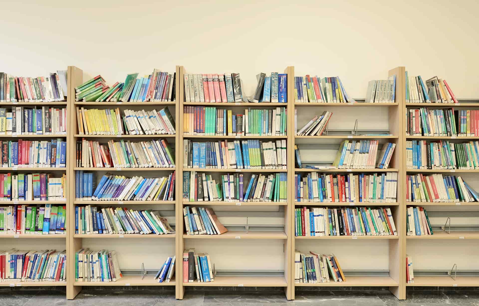 A tall bookshelf filled with books against a wall