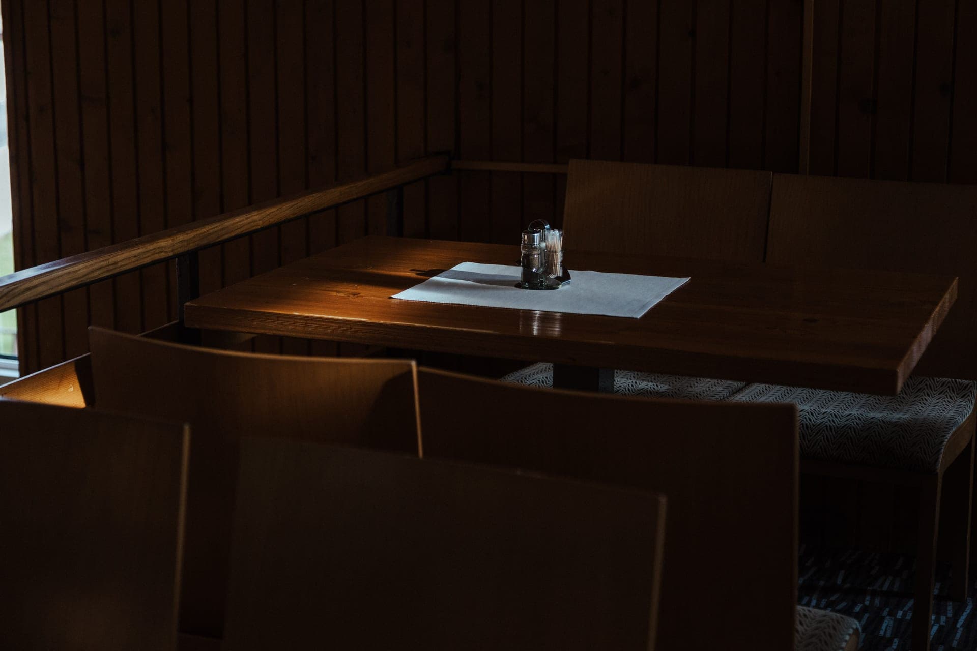 The corner of a low wooden table at a toddler's height