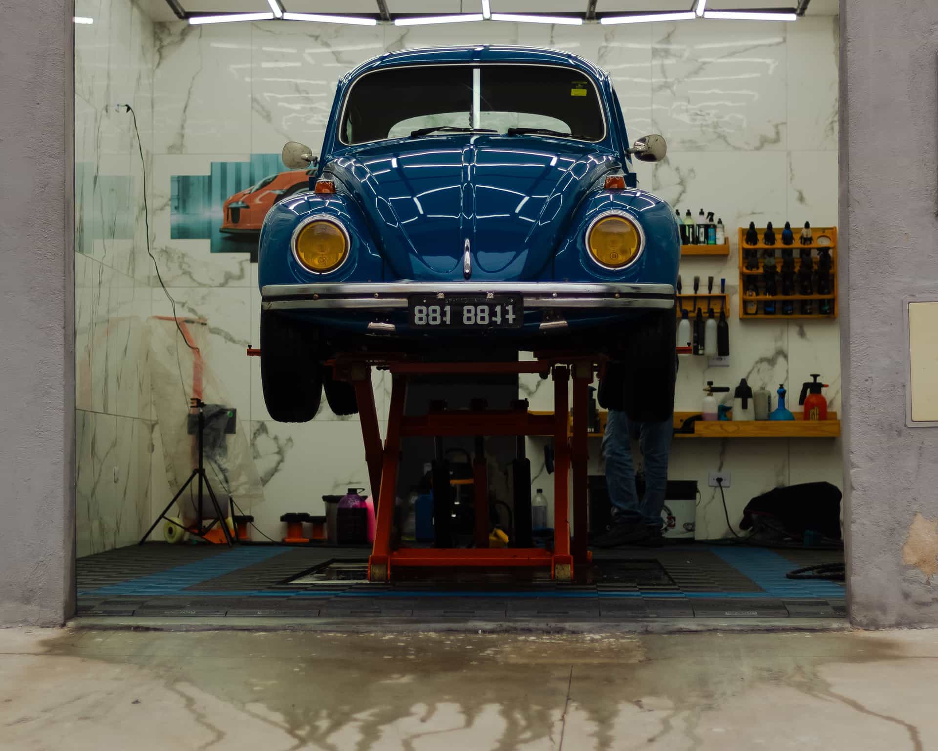 A garage with tools on the wall and a car parked inside