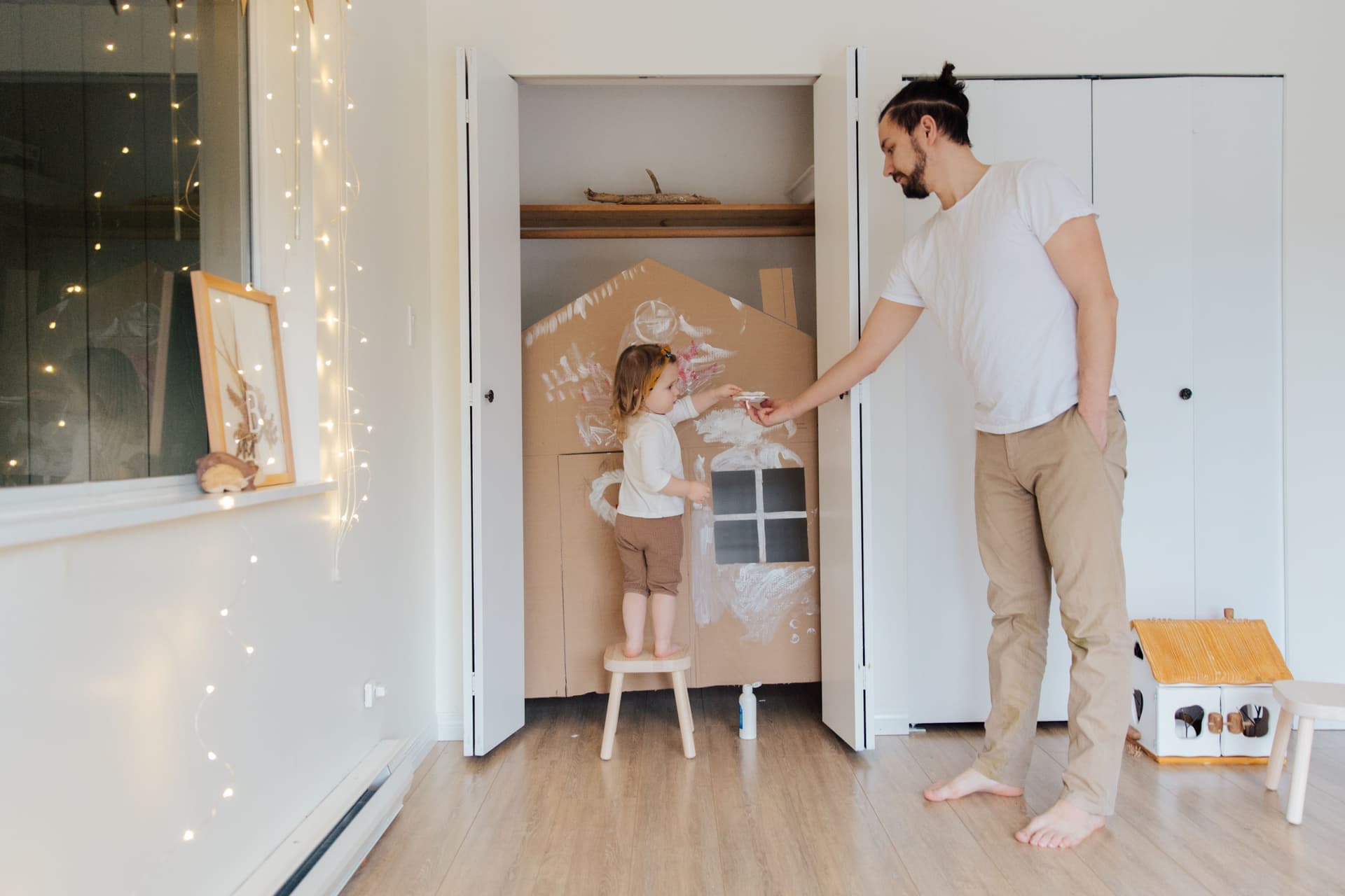A toddler standing on a step in a kitchen