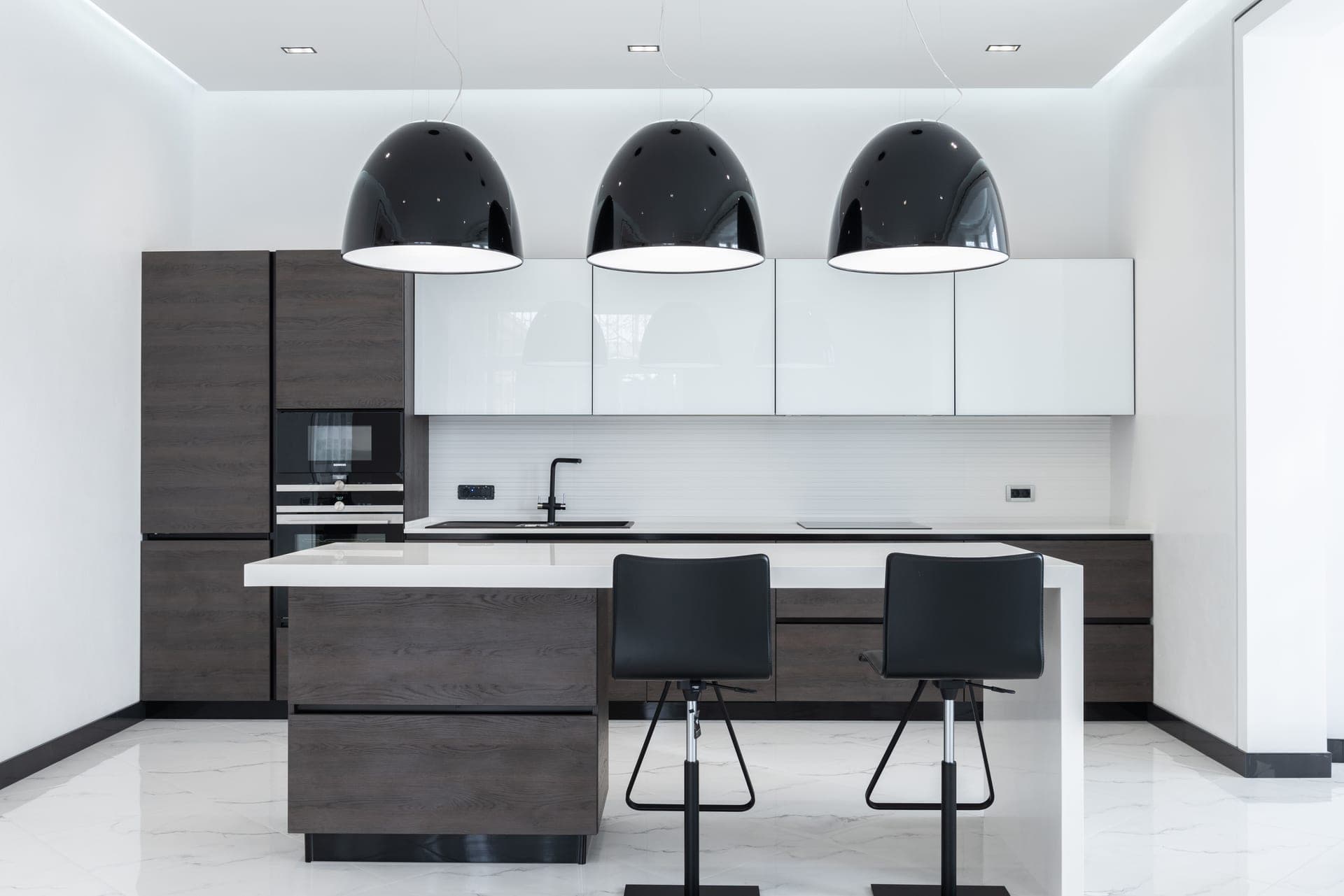 A bright kitchen with an island and lower cabinets
