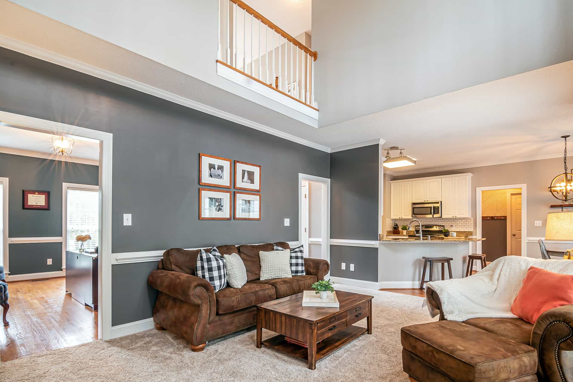 A living room with a sofa, coffee table and rug