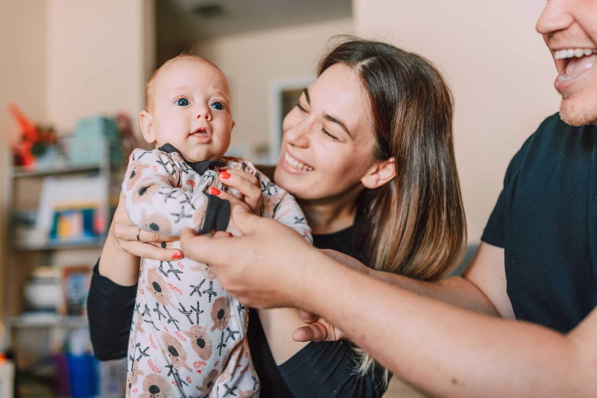 Parents holding a newborn baby at home