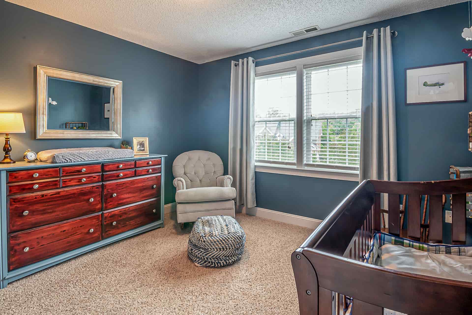A nursery with a crib and a dresser