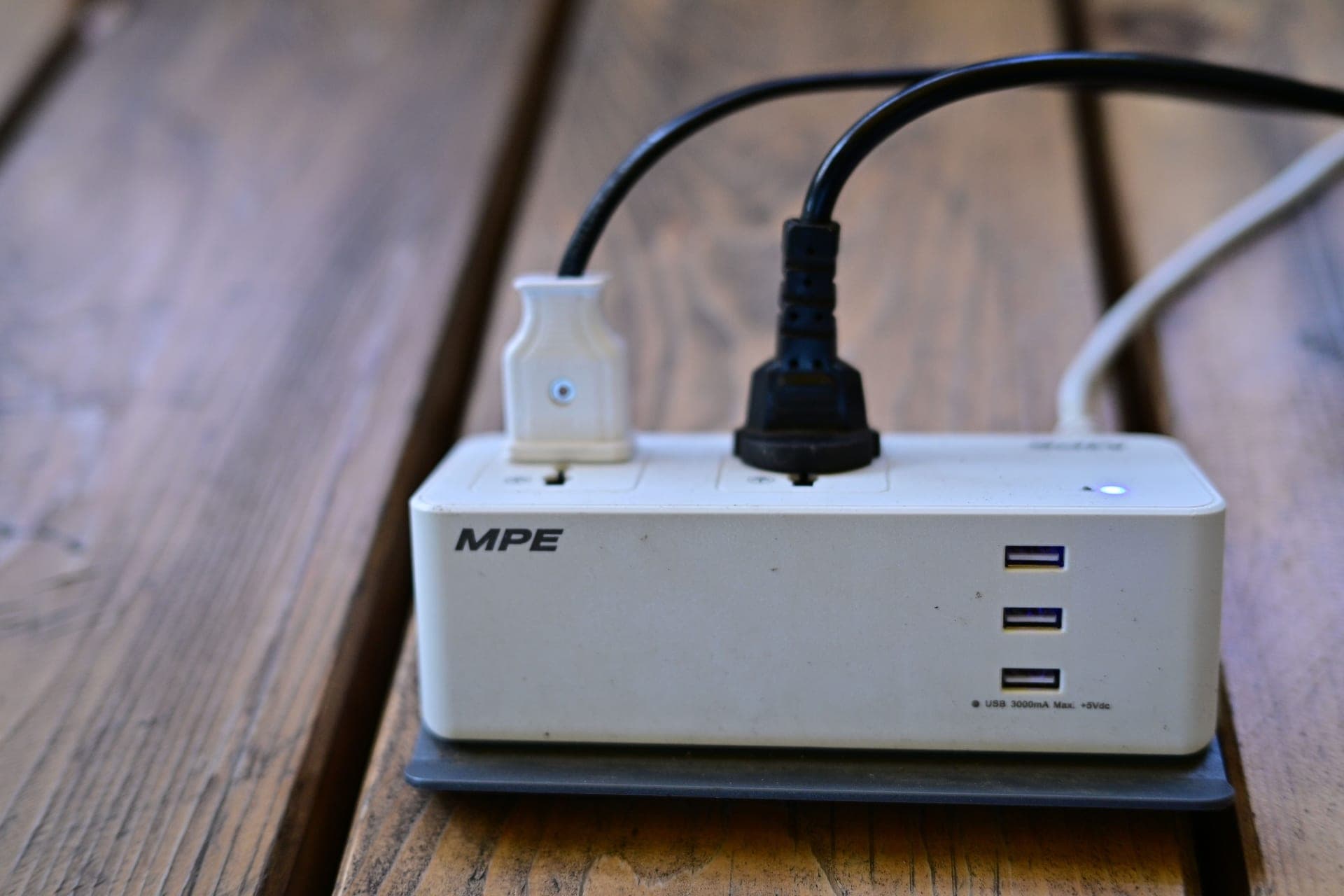 A power strip with several plugs on a floor