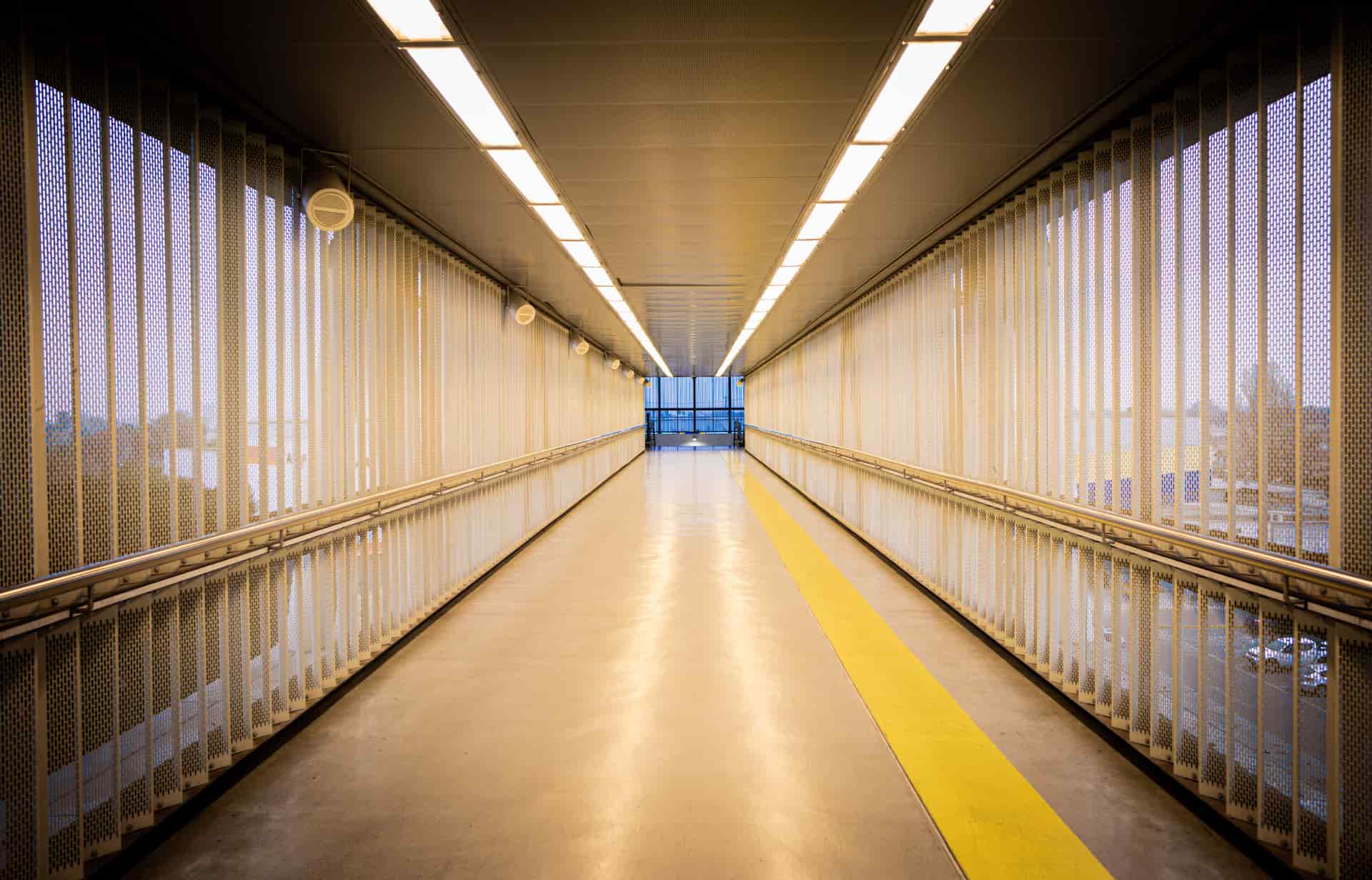 A mesh safety barrier stretched across a hallway
